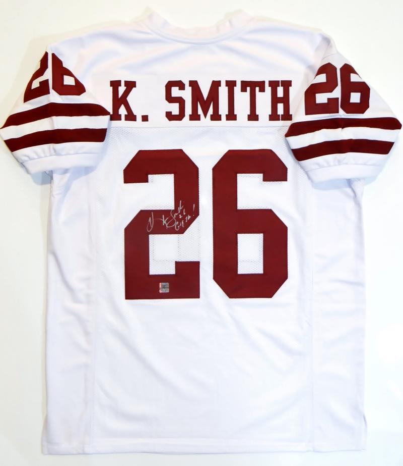 A Hendolph autographed white Aggie game jersey with K Smith's signature on it.