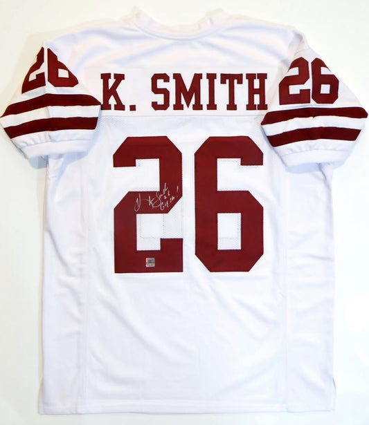 A Hendolph autographed white Aggie game jersey with K Smith's signature on it.