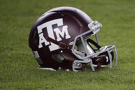 A Hendolph Autographed Maroon Aggie Helmet sits on the field.