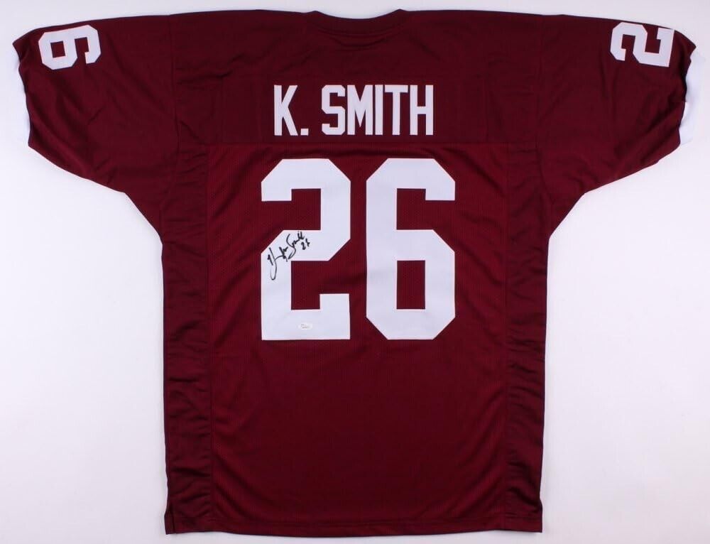 An Autographed Maroon Aggie Game Jersey with k smith's name on it, made by Hendolph.
