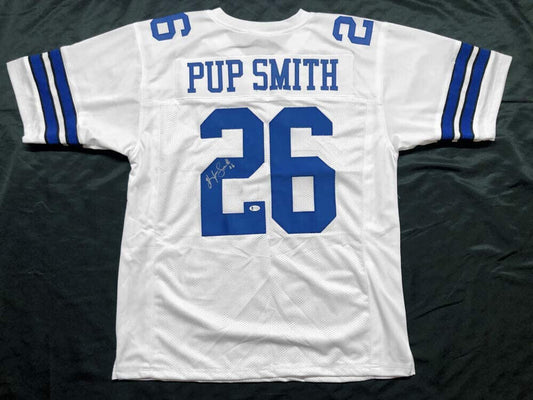 An Autographed White Dallas Cowboys Game Jersey with the number 26 on it by Hendolph.